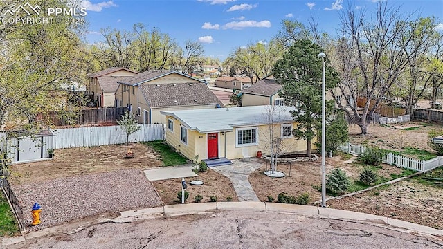 traditional home featuring a fenced backyard and stucco siding