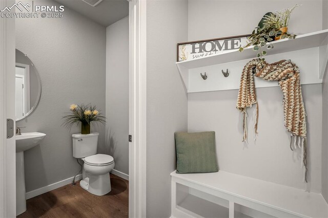 6375 Laud Pt, Colorado Springs, CO 80924 - half bathroom featuring toilet, wood finished floors, a sink, and baseboards