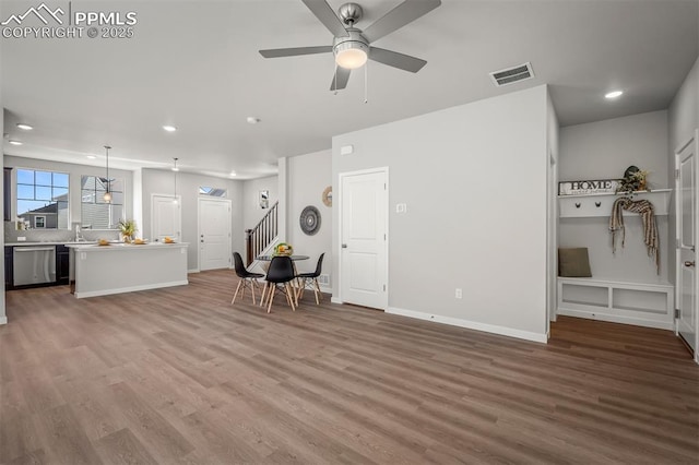 6375 Laud Pt, Colorado Springs, CO 80924 - living area featuring recessed lighting, stairs, visible vents, and wood finished floors
