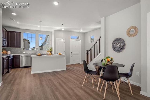6375 Laud Pt, Colorado Springs, CO 80924 - kitchen with dark brown cabinetry, visible vents, recessed lighting, appliances with stainless steel finishes, and wood finished floors