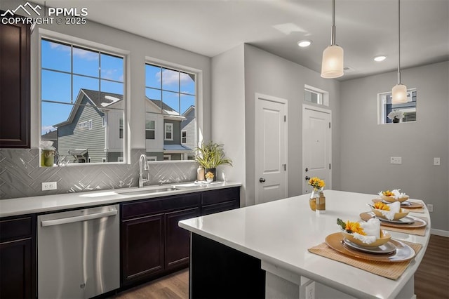 6375 Laud Pt, Colorado Springs, CO 80924 - kitchen featuring tasteful backsplash, dishwasher, a sink, light countertops, and wood finished floors