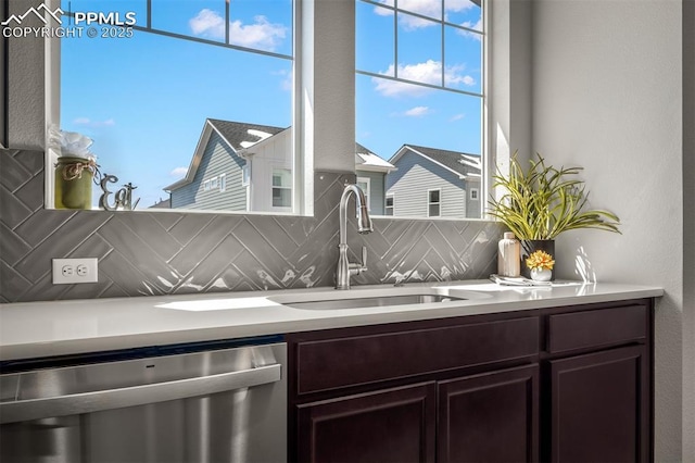 6375 Laud Pt, Colorado Springs, CO 80924 - bar featuring decorative backsplash, stainless steel dishwasher, a sink, and a wealth of natural light