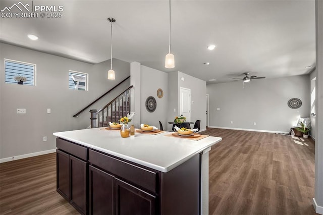 6375 Laud Pt, Colorado Springs, CO 80924 - kitchen with baseboards, light countertops, a ceiling fan, dark brown cabinets, and wood finished floors