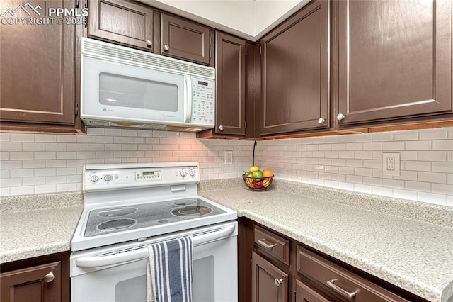 kitchen with white appliances, dark brown cabinetry, tasteful backsplash, and light countertops