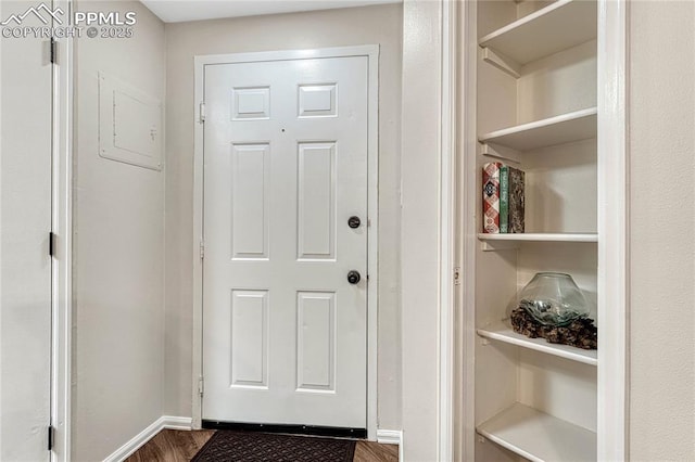 doorway to outside with baseboards and dark wood finished floors