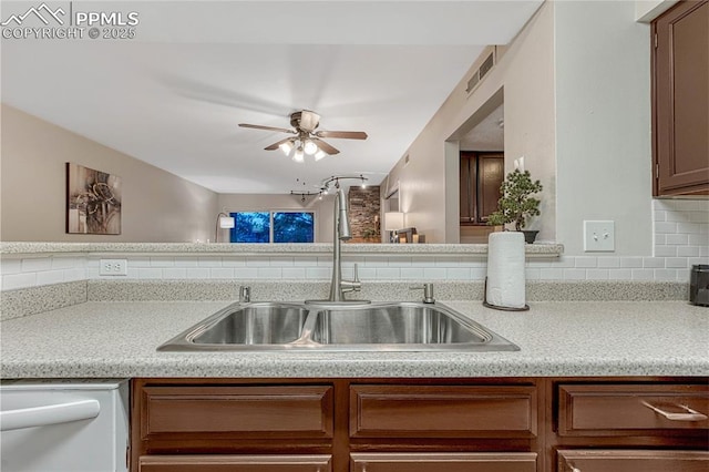 kitchen with ceiling fan, backsplash, visible vents, dishwasher, and a sink