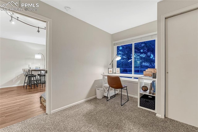carpeted office space featuring baseboards