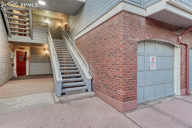 view of exterior entry with brick siding