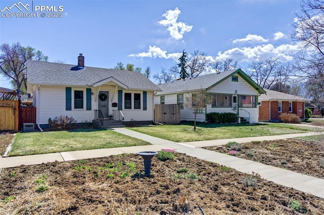bungalow with fence, a front lawn, a chimney, and a gate
