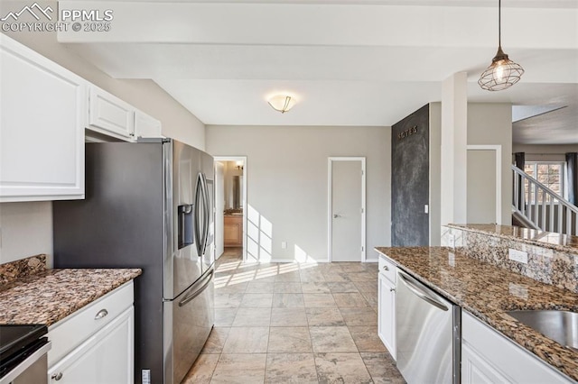 kitchen with dark stone countertops, pendant lighting, white cabinetry, baseboards, and appliances with stainless steel finishes