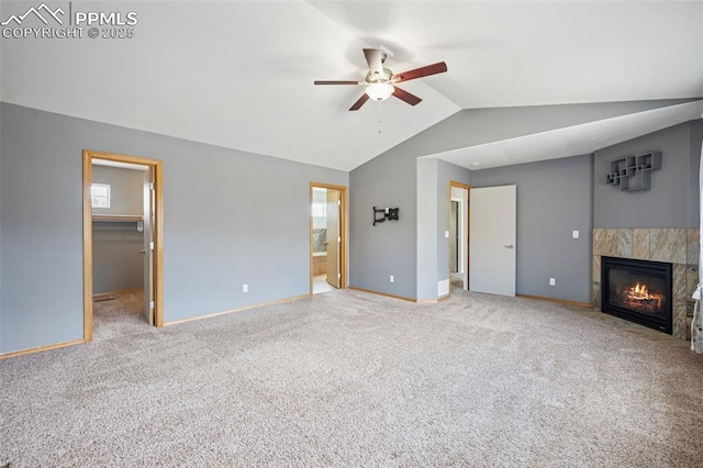 unfurnished living room with baseboards, carpet, lofted ceiling, a ceiling fan, and a fireplace