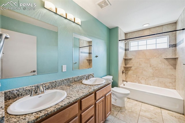 bathroom featuring toilet, shower / washtub combination, a sink, and visible vents
