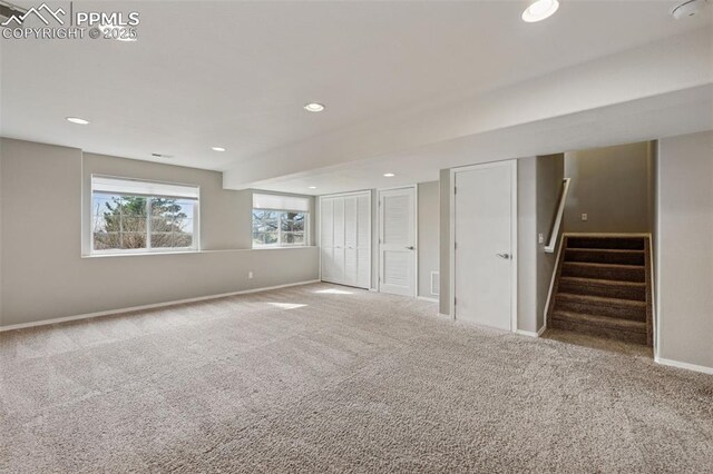 basement with recessed lighting, carpet, stairs, and baseboards