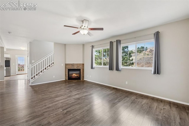 unfurnished living room with wood finished floors, a ceiling fan, and baseboards