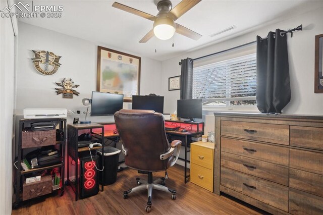 office space with visible vents, wood finished floors, and ceiling fan