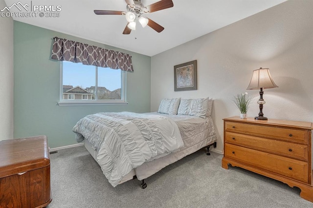 carpeted bedroom featuring baseboards and ceiling fan