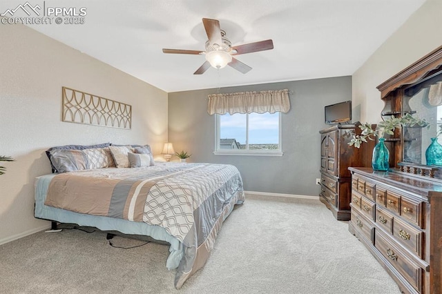 bedroom with light colored carpet, baseboards, and ceiling fan