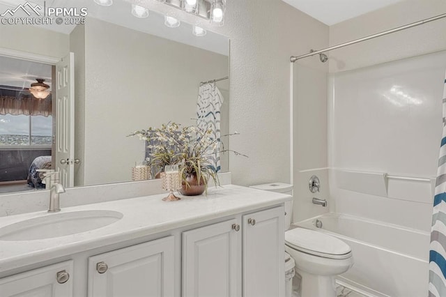 bathroom with toilet, a textured wall, vanity, and shower / tub combo