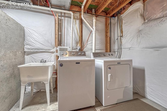 clothes washing area with washing machine and clothes dryer