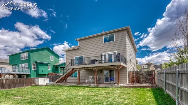 rear view of property with a storage unit, stairway, an outdoor structure, and a deck