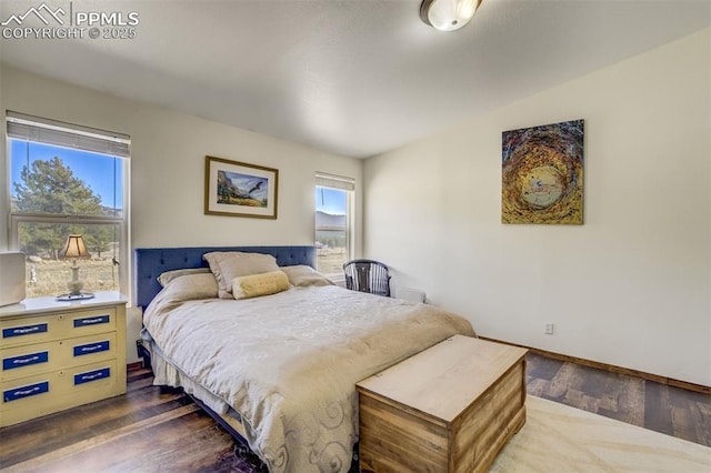 bedroom with baseboards and wood-type flooring