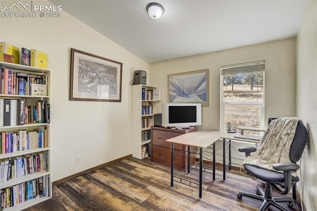 office area featuring vaulted ceiling, wood finished floors, and baseboards