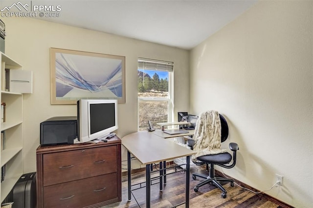 home office featuring wood finished floors and baseboards