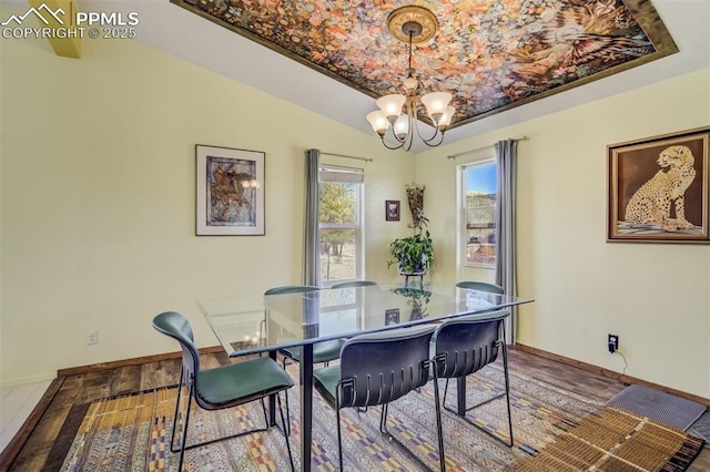 dining area with a notable chandelier and baseboards