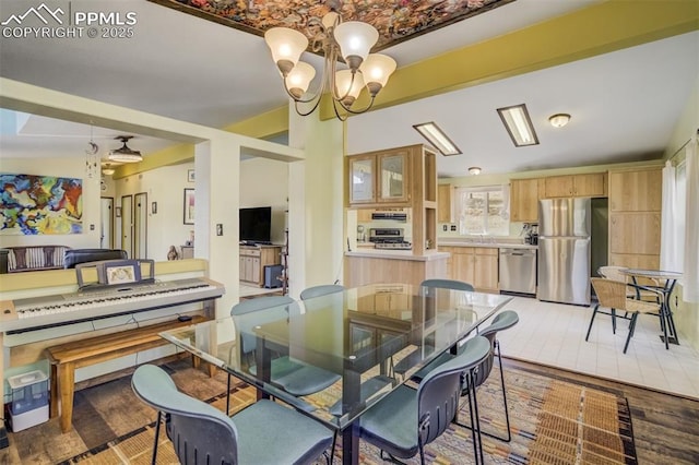 dining space with a notable chandelier and light wood-style flooring