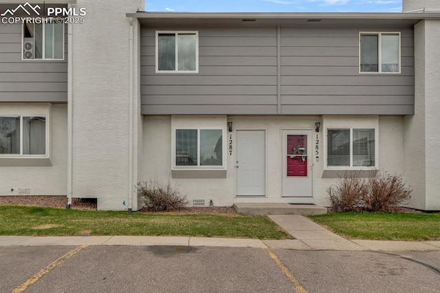 1287 Soaring Eagle Dr, Colorado Springs, CO 80915 - view of property featuring uncovered parking and stucco siding