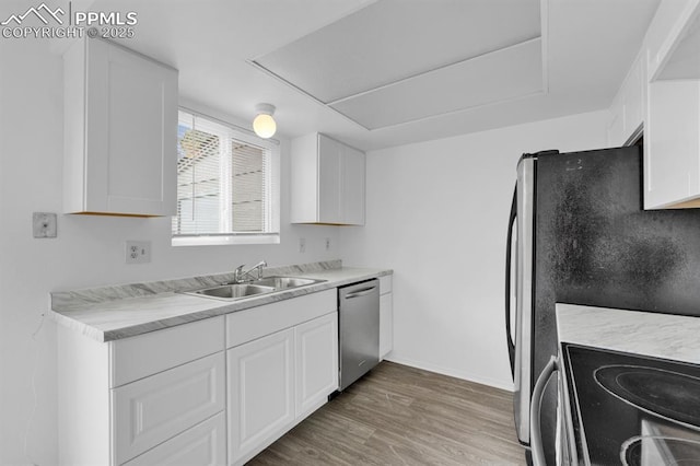 1287 Soaring Eagle Dr, Colorado Springs, CO 80915 - kitchen with white cabinets, light wood finished floors, appliances with stainless steel finishes, and a sink