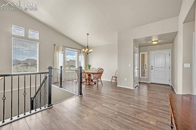 8421 Crooked Branch Ln, Colorado Springs, CO 80927 - interior space with baseboards, wood finished floors, a chandelier, and vaulted ceiling
