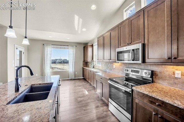 8421 Crooked Branch Ln, Colorado Springs, CO 80927 - kitchen featuring wood finished floors, recessed lighting, tasteful backsplash, a sink, and appliances with stainless steel finishes