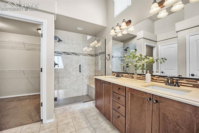 8421 Crooked Branch Ln, Colorado Springs, CO 80927 - full bathroom featuring a sink, backsplash, a stall shower, and double vanity