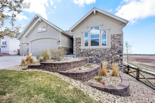8421 Crooked Branch Ln, Colorado Springs, CO 80927 - view of front of home featuring fence, an attached garage, stone siding, stucco siding, and concrete driveway