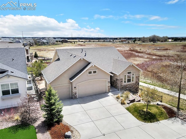 8421 Crooked Branch Ln, Colorado Springs, CO 80927 - view of front of home featuring an attached garage, driveway, stucco siding, and stone siding