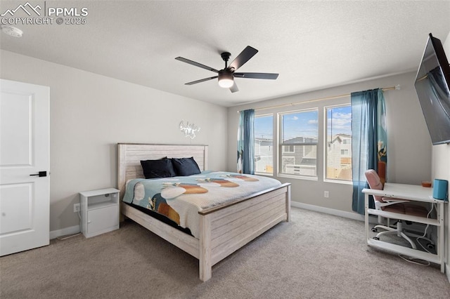 bedroom with a ceiling fan, baseboards, and light colored carpet