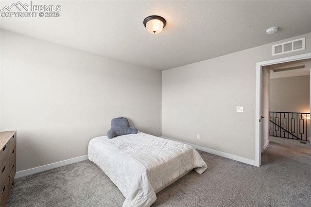 carpeted bedroom featuring baseboards and visible vents
