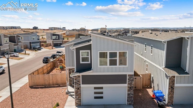 view of front facade with board and batten siding, stone siding, and a residential view