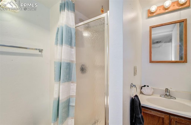 full bath with a stall shower and vanity