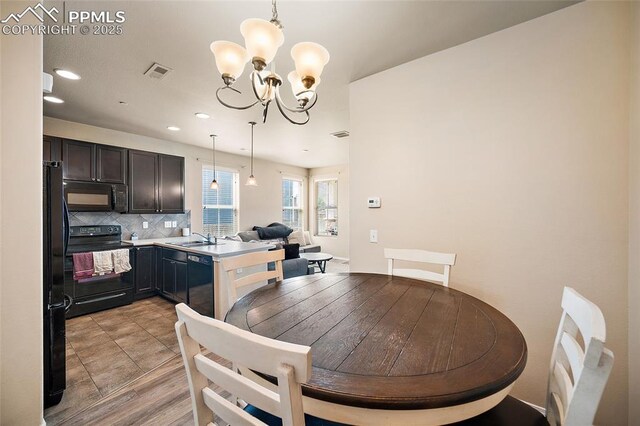 2404 Obsidian Forest Vw, Colorado Springs, CO 80951 - dining area featuring visible vents, an inviting chandelier, and recessed lighting