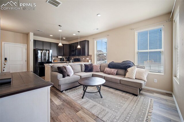 2404 Obsidian Forest Vw, Colorado Springs, CO 80951 - living room featuring visible vents, recessed lighting, light wood-style flooring, and baseboards