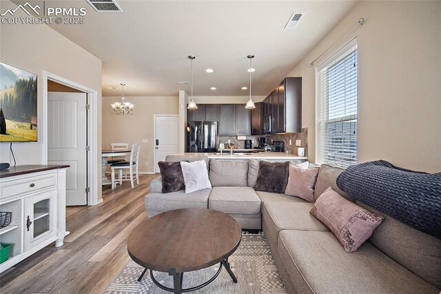 2404 Obsidian Forest Vw, Colorado Springs, CO 80951 - living room featuring an inviting chandelier, visible vents, light wood-type flooring, and recessed lighting