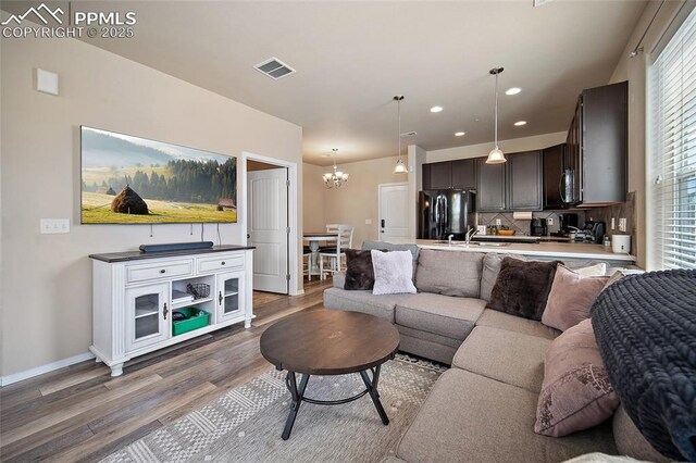 2404 Obsidian Forest Vw, Colorado Springs, CO 80951 - living area with recessed lighting, wood finished floors, a chandelier, baseboards, and visible vents