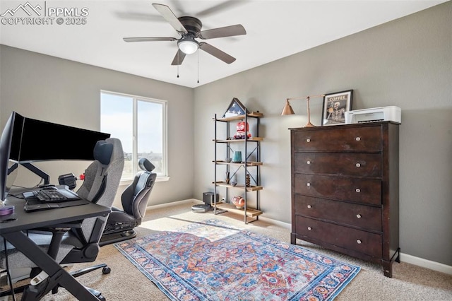 carpeted home office with baseboards and a ceiling fan