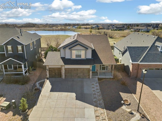 drone / aerial view featuring a water view and a residential view