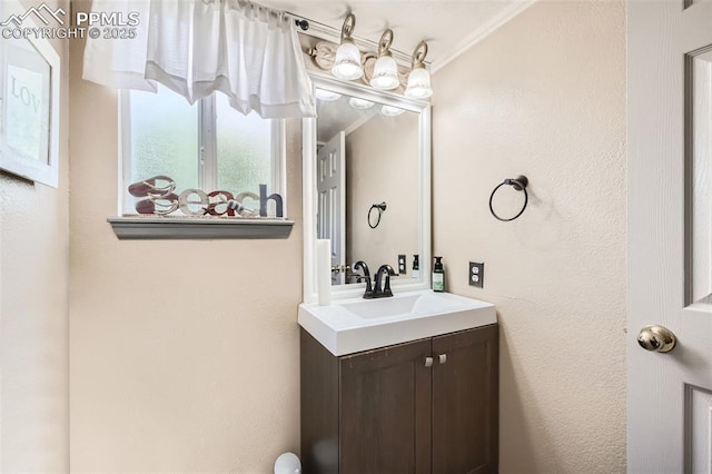 bathroom featuring vanity and crown molding