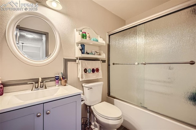 bathroom with toilet, enclosed tub / shower combo, and vanity