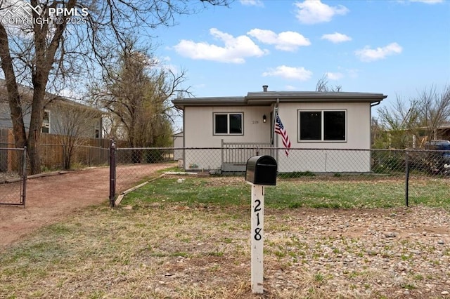 view of front facade with fence private yard and a front lawn