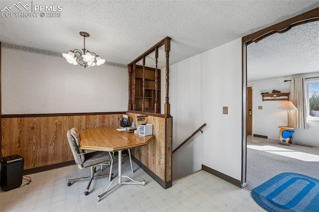 dining space featuring baseboards, a chandelier, tile patterned floors, and a textured ceiling